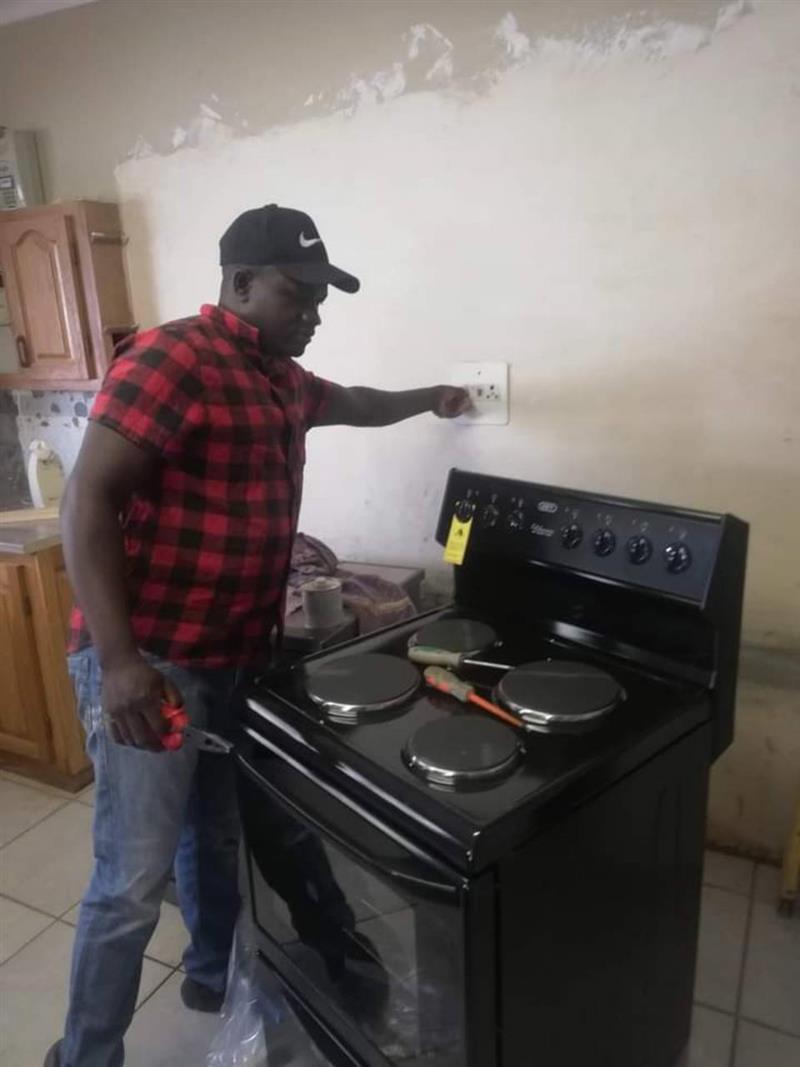 Electrician checking a kitchen stove power point