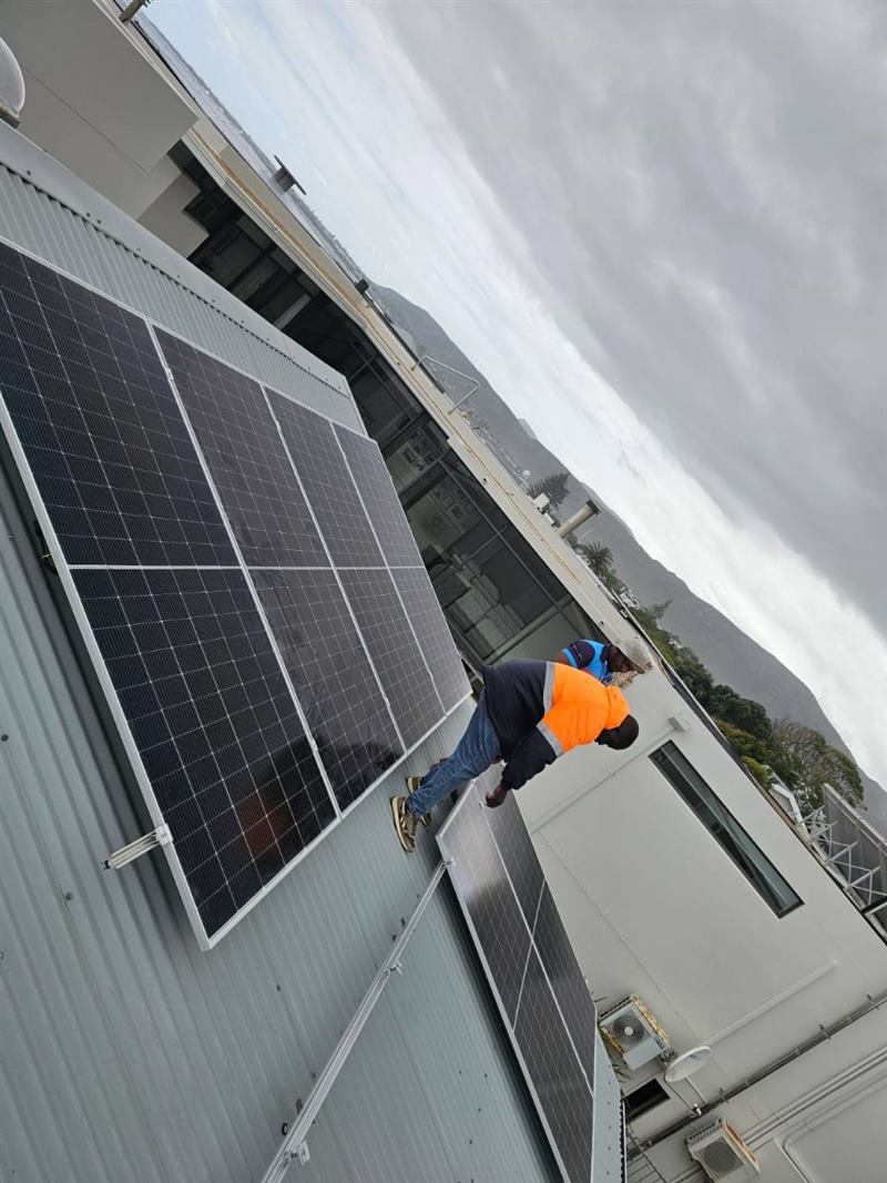 Team working on rooftop solar panel installation